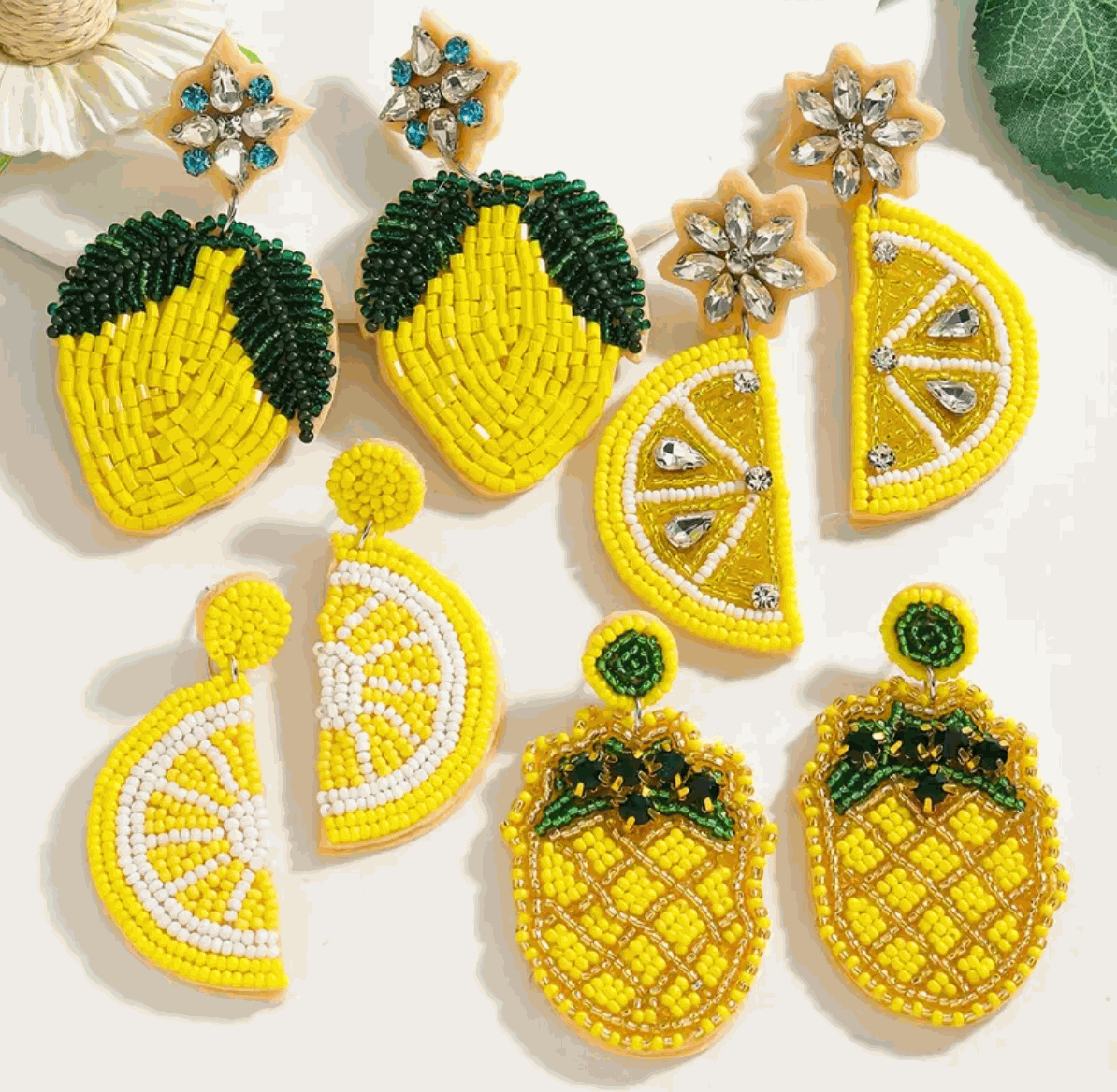 Vibrant hand-beaded yellow citrus earrings featuring lemons, limes, and pineapples, perfect for a fun summer look.