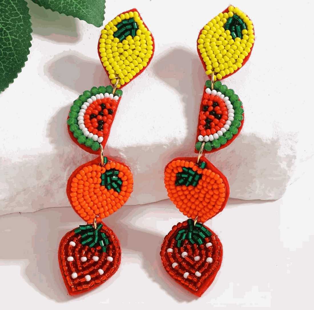 Colorful hand-beaded fruit earrings featuring lemon, watermelon, orange, and strawberry designs for a playful summer look.